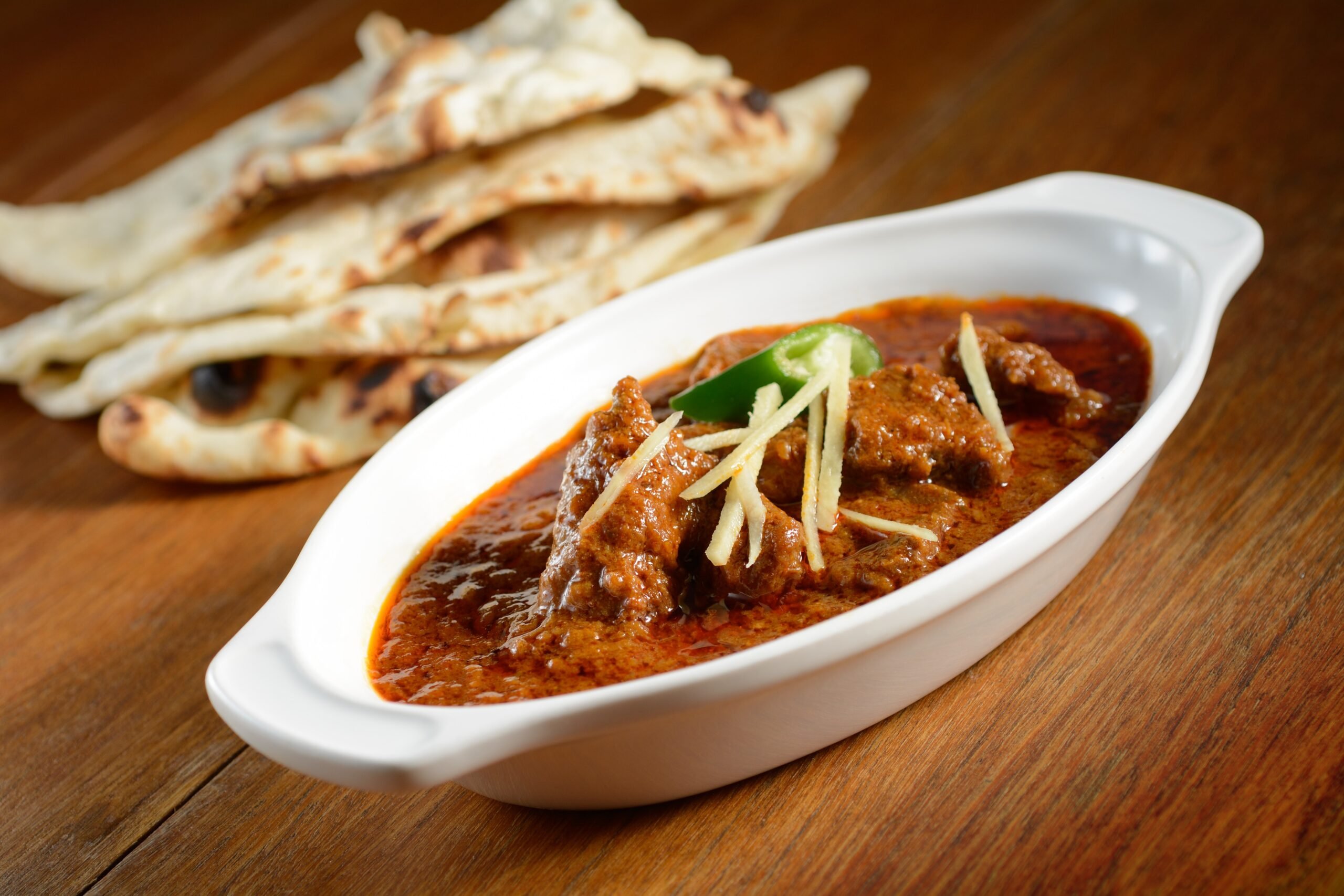 Assorted Indian desserts including gulab jamun
